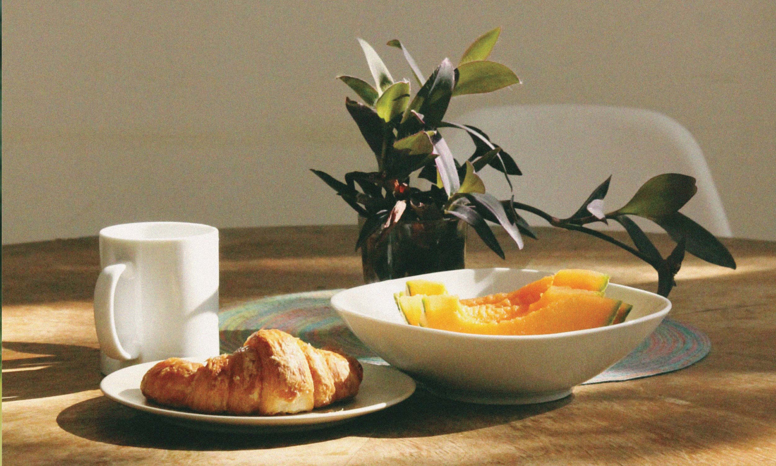 Breakfast with a croissant, melon and coffee, illustrating how food turns into energy