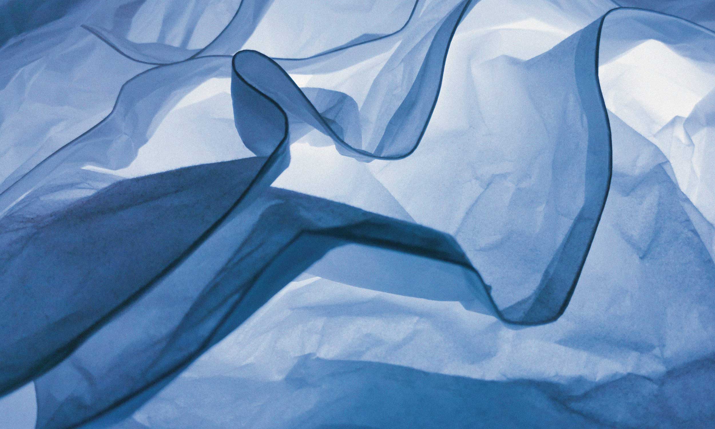 Abstract blue fabric flowing in soft folds, symbolising calm, spaciousness and room to breathe.