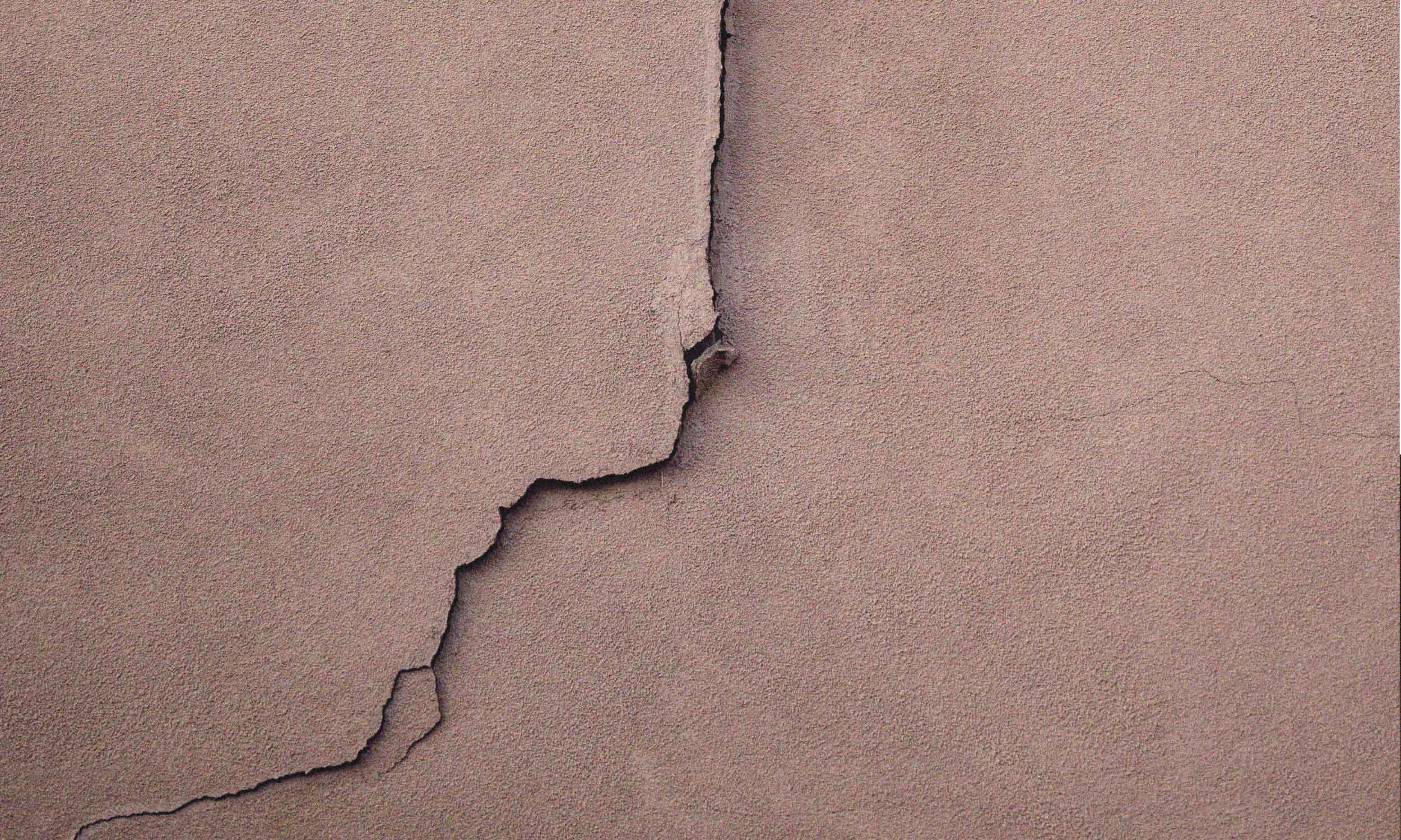 Cracked wall symbolising how assumptions damage relationships and create emotional distance